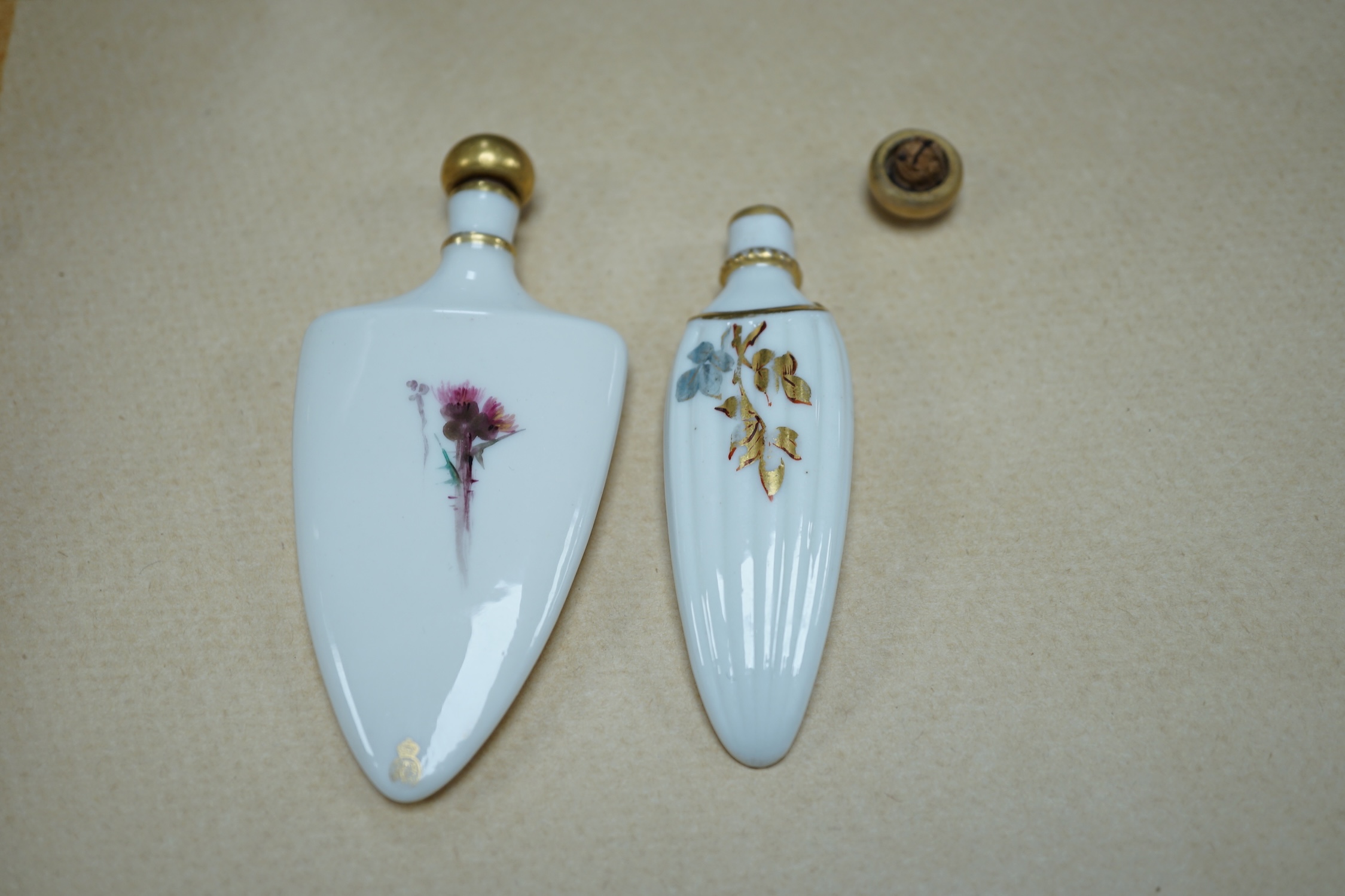 An unusual Royal Worcester bird painted scent flask and another similar flask, longest 10cm. Condition - cork to one stopper broken, unsigned